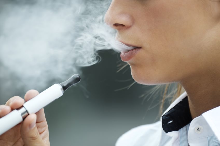 21031772 - closeup of woman smoking e-cigarette and enjoying smoke. copy space 21031772 - closeup of woman smoking e-cigarette and enjoying smoke. copy space